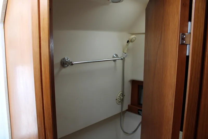 Irish Luck Yacht Photos Pics 2002 Mainship Pilot 34 boat shower area with wooden door and handheld showerhead.