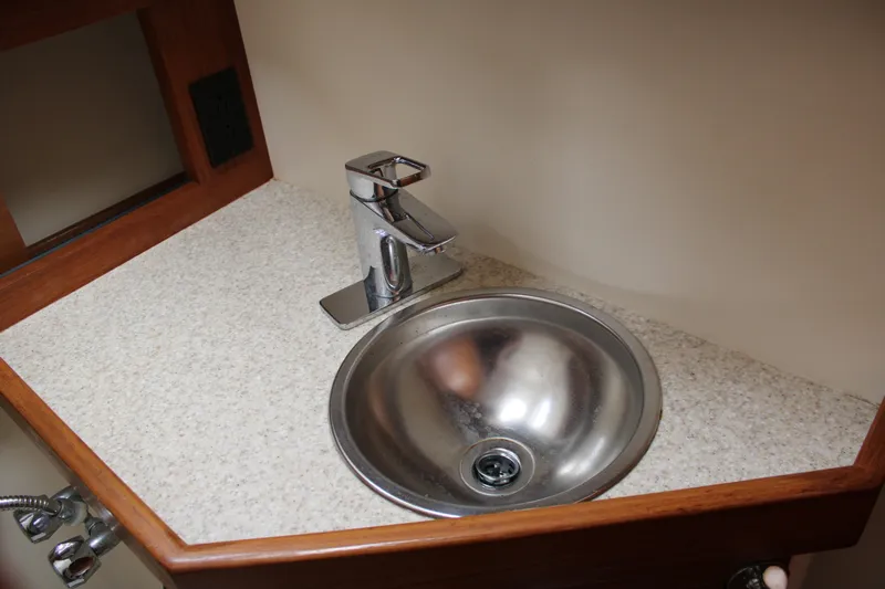 Irish Luck Yacht Photos Pics Stainless steel sink and faucet in 2002 Mainship Pilot 34 boat interior.