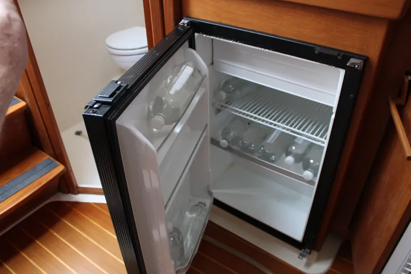 Irish Luck Yacht Photos Pics Open mini fridge with bottles inside on a 2002 Mainship Pilot 34 boat.