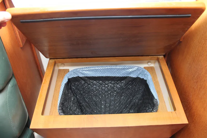 Irish Luck Yacht Photos Pics Wooden storage compartment with trash bin liner on 2002 Mainship Pilot 34 boat.