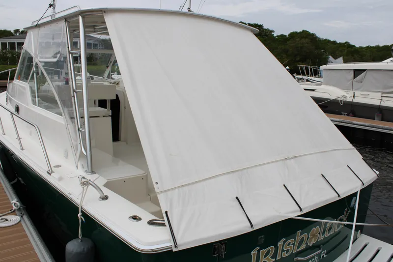 Irish Luck Yacht Photos Pics 2002 Mainship Pilot 34 boat docked with white canopy cover.