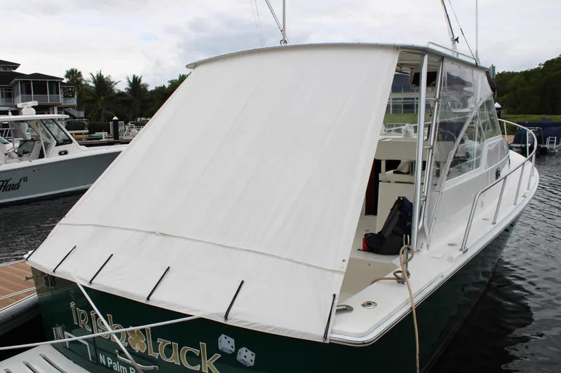 Irish Luck Yacht Photos Pics 2002 Mainship Pilot 34 boat docked with white canopy cover.