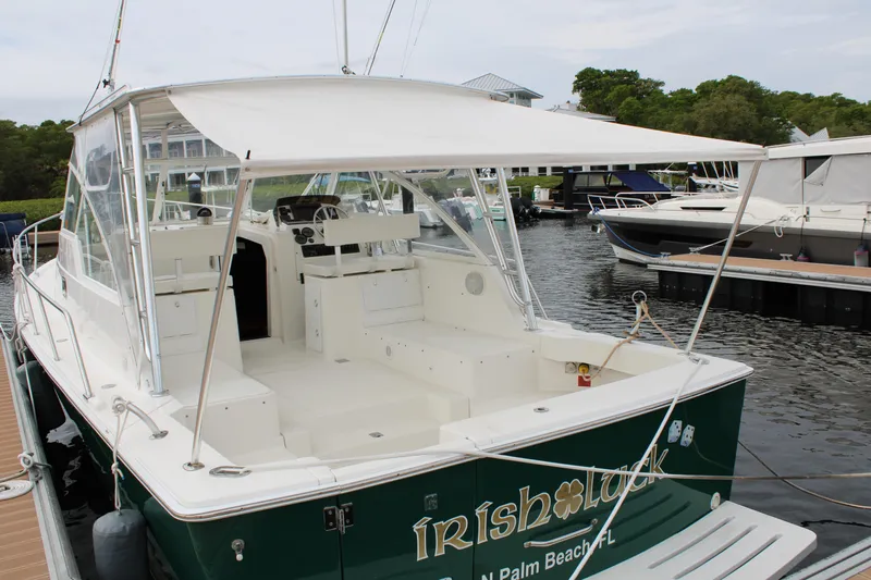 Irish Luck Yacht Photos Pics 2002 Mainship Pilot 34 boat docked, featuring spacious deck and canopy, named "Irish Luck."