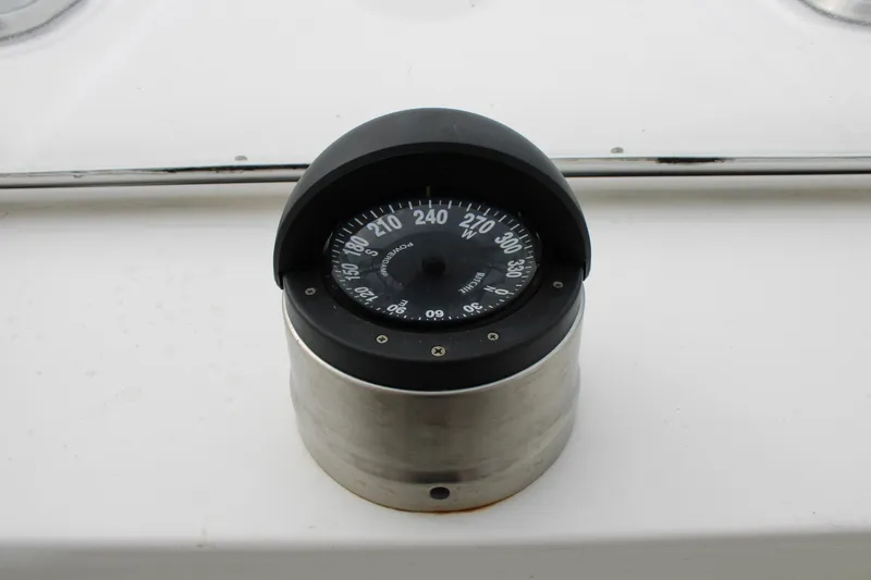 Irish Luck Yacht Photos Pics Compass on 2002 Mainship Pilot 34 boat dashboard, displaying navigational directions.