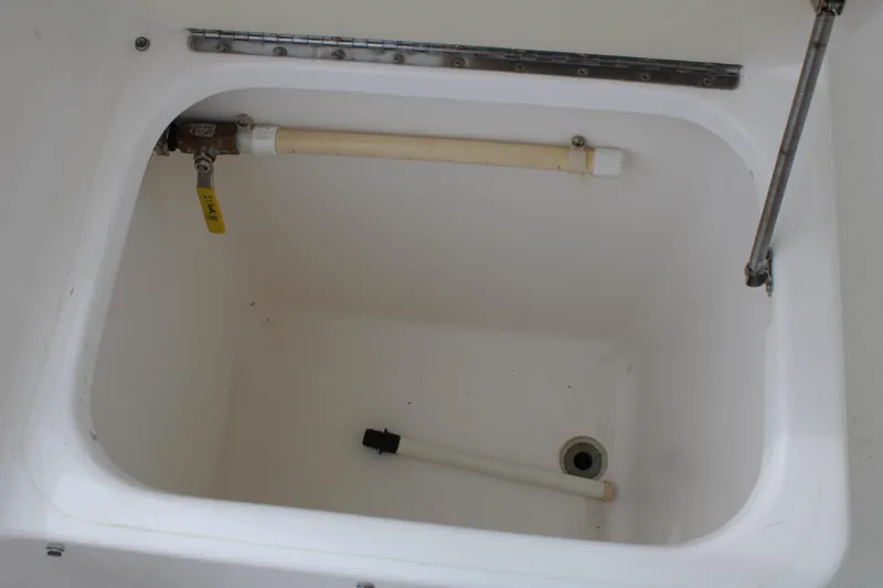 Irish Luck Yacht Photos Pics 2002 Mainship Pilot 34 boat compartment with valve and drainage pipe.