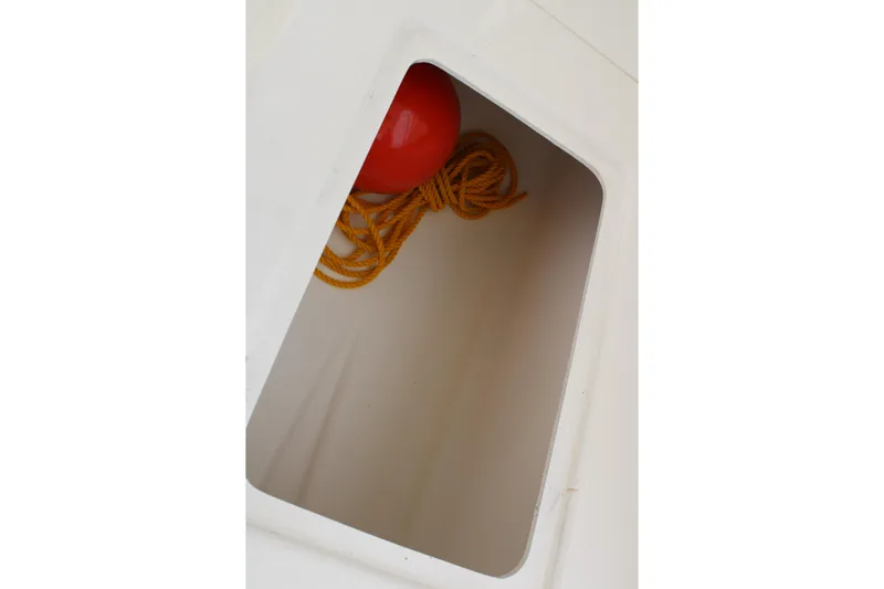 Irish Luck Yacht Photos Pics Storage compartment on 2002 Mainship Pilot 34 with red buoy and yellow rope.