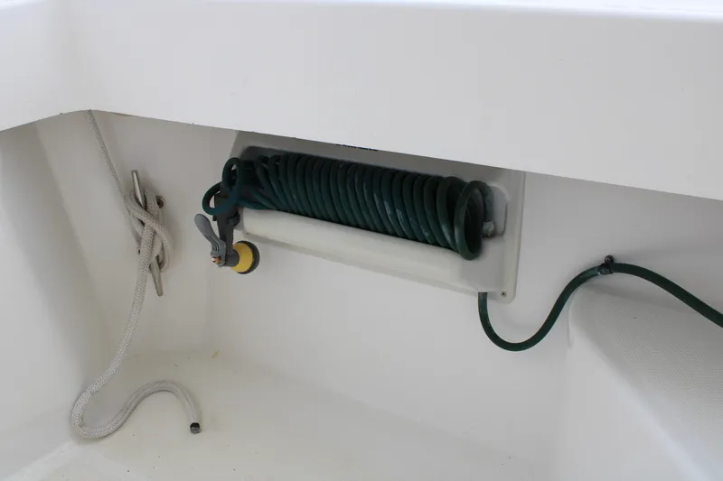 Irish Luck Yacht Photos Pics Coiled hose and rope storage on 2002 Mainship Pilot 34 boat deck.