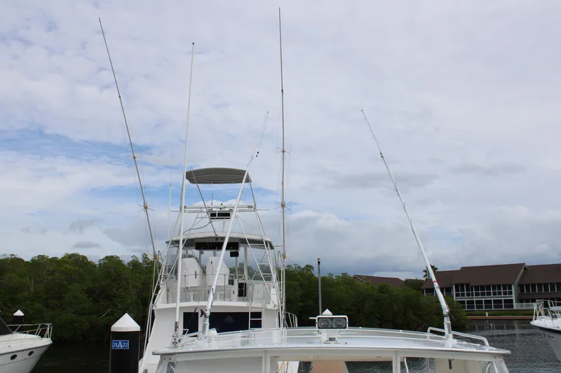 Irish Luck Yacht Photos Pics 2002 Mainship Pilot 34 docked, featuring tall antennas and a clear sky backdrop.
