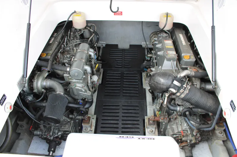 Irish Luck Yacht Photos Pics Engine compartment of a 2002 Mainship Pilot 34 boat, showcasing dual engines.