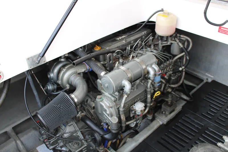 Irish Luck Yacht Photos Pics Engine compartment of a 2002 Mainship Pilot 34 boat, showcasing detailed mechanical components.