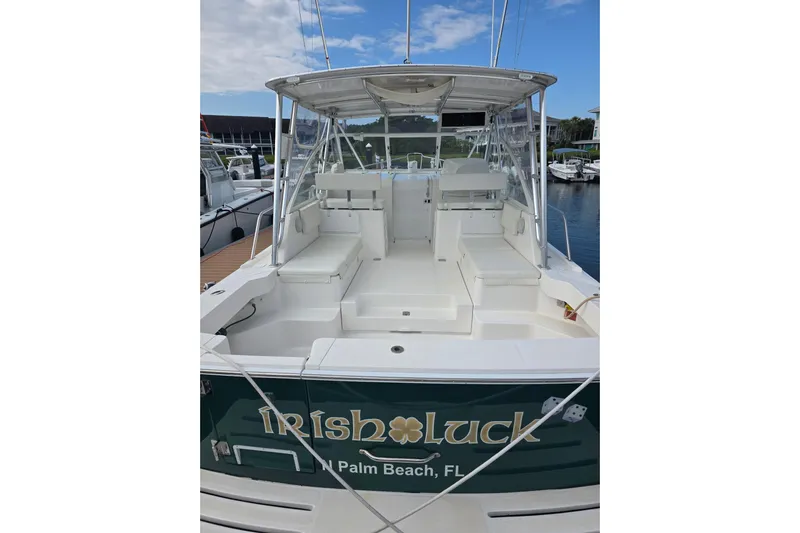 Irish Luck Yacht Photos Pics 2002 Mainship Pilot 34 boat docked, featuring spacious seating and canopy, labeled "Irish Luck."