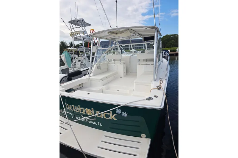 Irish Luck Yacht Photos Pics 2002 Mainship Pilot 34 boat docked, featuring spacious seating and canopy, named "Irish Luck."