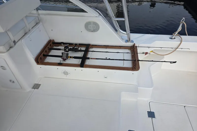 Irish Luck Yacht Photos Pics 2002 Mainship Pilot 34 boat deck with fishing rod holders and seating area.