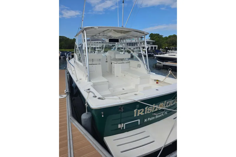 Irish Luck Yacht Photos Pics 2002 Mainship Pilot 34 boat docked, featuring spacious deck and canopy, in marina setting.