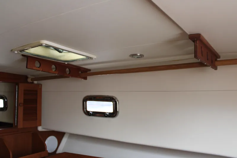 Irish Luck Yacht Photos Pics Interior of 2002 Mainship Pilot 34 boat, featuring wooden accents and a small window.