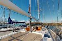 Luxurious 2012 Amel 64 yacht docked, showcasing spacious deck and elegant design.