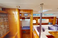 Luxurious interior of 2012 Amel 64 yacht with elegant wood finish and plush seating.
