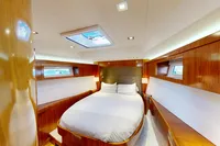 Luxurious cabin interior of 2012 Amel 64 yacht with wood finish and skylight.