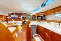 Luxurious interior of 2012 Amel 64 yacht with modern kitchen and seating area.