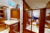 Luxurious interior of 2012 Amel 64 yacht featuring wood finishes and modern amenities.