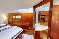 Luxurious Amel 64 yacht interior, featuring elegant wood finishes and a cozy bedroom, 2012 model.