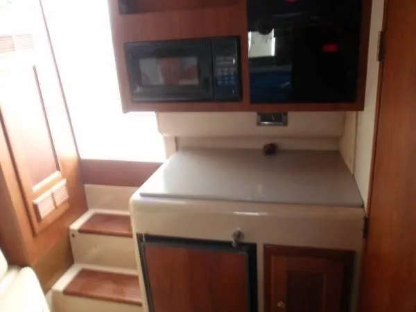 Rampage Yacht Photos Pics 2001 Rampage 30 Express boat interior with microwave and compact fridge.