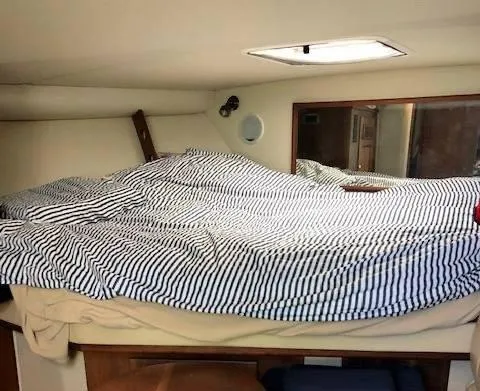 Rampage Yacht Photos Pics Interior cabin of 2001 Rampage 30 Express with striped bedding.