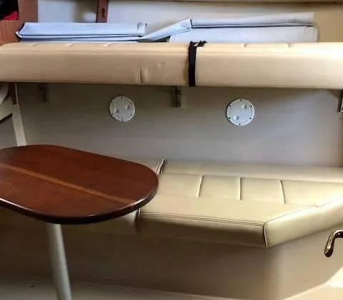 Rampage Yacht Photos Pics Interior of 2001 Rampage 30 Express boat with beige seating and wooden table.