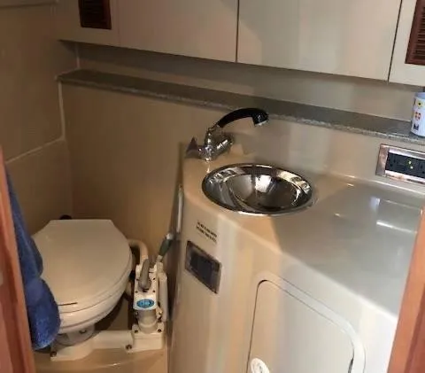 Rampage Yacht Photos Pics Compact bathroom in a 2001 Rampage 30 Express boat, featuring a toilet and sink.