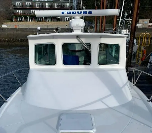 Rampage Yacht Photos Pics 2001 Rampage 30 Express boat with Furuno radar, docked near waterfront buildings.