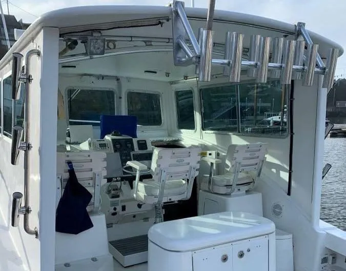 Rampage Yacht Photos Pics 2001 Rampage 30 Express boat interior with helm, seating, and rod holders.