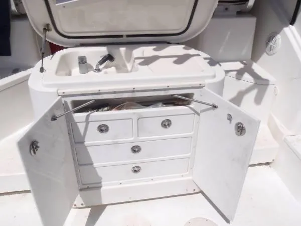 Rampage Yacht Photos Pics 2001 Rampage 30 Express boat interior with open storage cabinets and sink.