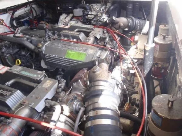 Rampage Yacht Photos Pics Engine compartment of a 2001 Rampage 30 Express boat, showcasing mechanical components and wiring.