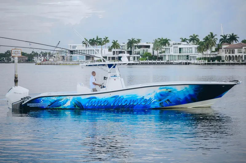  Yacht Photos Pics 2007 Yellowfin 36 Offshore boat with vibrant blue graphics on calm water.