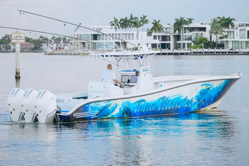  Yacht Photos Pics 2007 Yellowfin 36 Offshore boat with vibrant ocean-themed graphics on calm water.