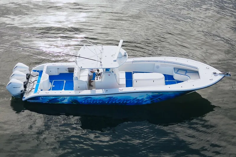  Yacht Photos Pics 2007 Yellowfin 36 Offshore boat with triple Mercury engines on calm water.