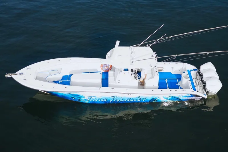  Yacht Photos Pics 2007 Yellowfin 36 Offshore boat with vibrant blue accents on calm water.