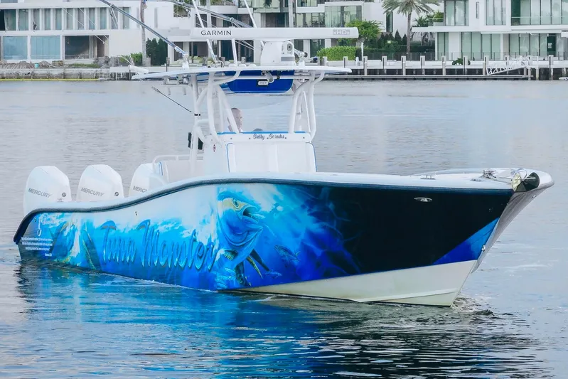  Yacht Photos Pics 2007 Yellowfin 36 Offshore boat with vibrant marine-themed hull design on the water.