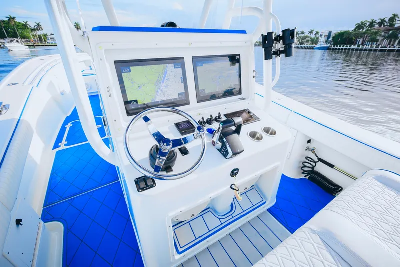  Yacht Photos Pics 2007 Yellowfin 36 Offshore boat cockpit with dual navigation screens and blue accents.