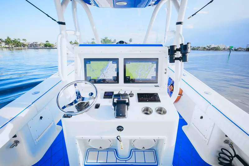  Yacht Photos Pics 2007 Yellowfin 36 Offshore boat cockpit with dual navigation screens and steering wheel.