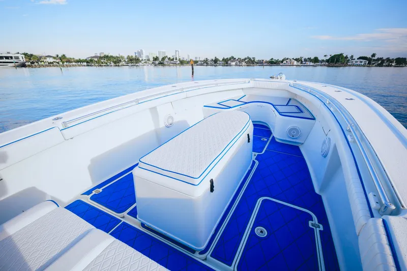  Yacht Photos Pics 2007 Yellowfin 36 Offshore boat with blue deck, spacious seating, and scenic waterfront view.