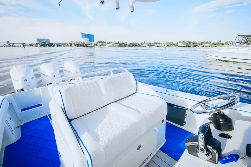  Yacht Photos Pics 2007 Yellowfin 36 Offshore boat interior with white seating and blue flooring on calm water.