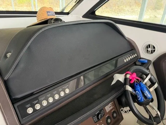  Yacht Photos Pics Dashboard of a 2016 Cobalt A40 boat with steering wheel and controls.