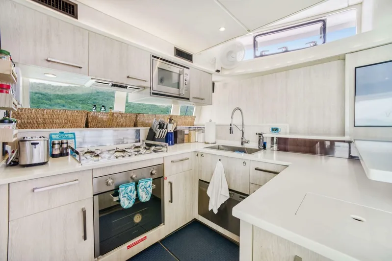 Deep Blue Yacht Photos Pics Modern kitchen interior on 2016 Leopard 58 Catamaran with sleek appliances and ample counter space.