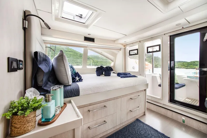 Deep Blue Yacht Photos Pics Luxurious bedroom interior of 2016 Leopard 58 Catamaran with scenic window views.
