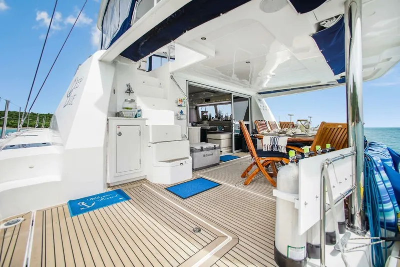 Deep Blue Yacht Photos Pics Luxurious 2016 Leopard 58 Catamaran deck with dining area, ocean view, and modern amenities.