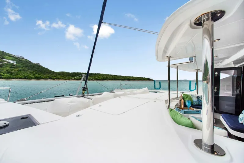 Deep Blue Yacht Photos Pics Leopard 58 Catamaran 2016 on tranquil waters, featuring spacious deck and luxurious seating.