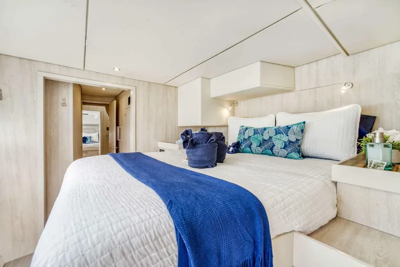 Deep Blue Yacht Photos Pics Luxurious bedroom interior of 2016 Leopard 58 Catamaran with elegant bedding and decor.