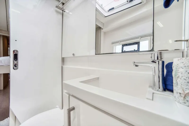 Deep Blue Yacht Photos Pics Modern bathroom interior on a 2016 Leopard 58 Catamaran, featuring sleek fixtures and a window.