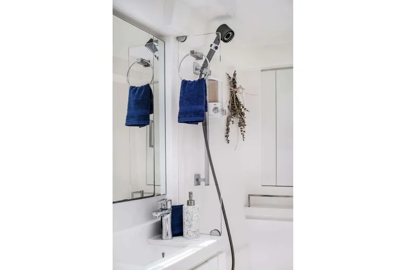 Deep Blue Yacht Photos Pics Modern bathroom in 2016 Leopard 58 Catamaran with blue towel and sleek fixtures.